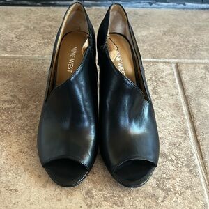 Nine West, black, leather open toe pumps. Cutout on side. Inside is peeling.